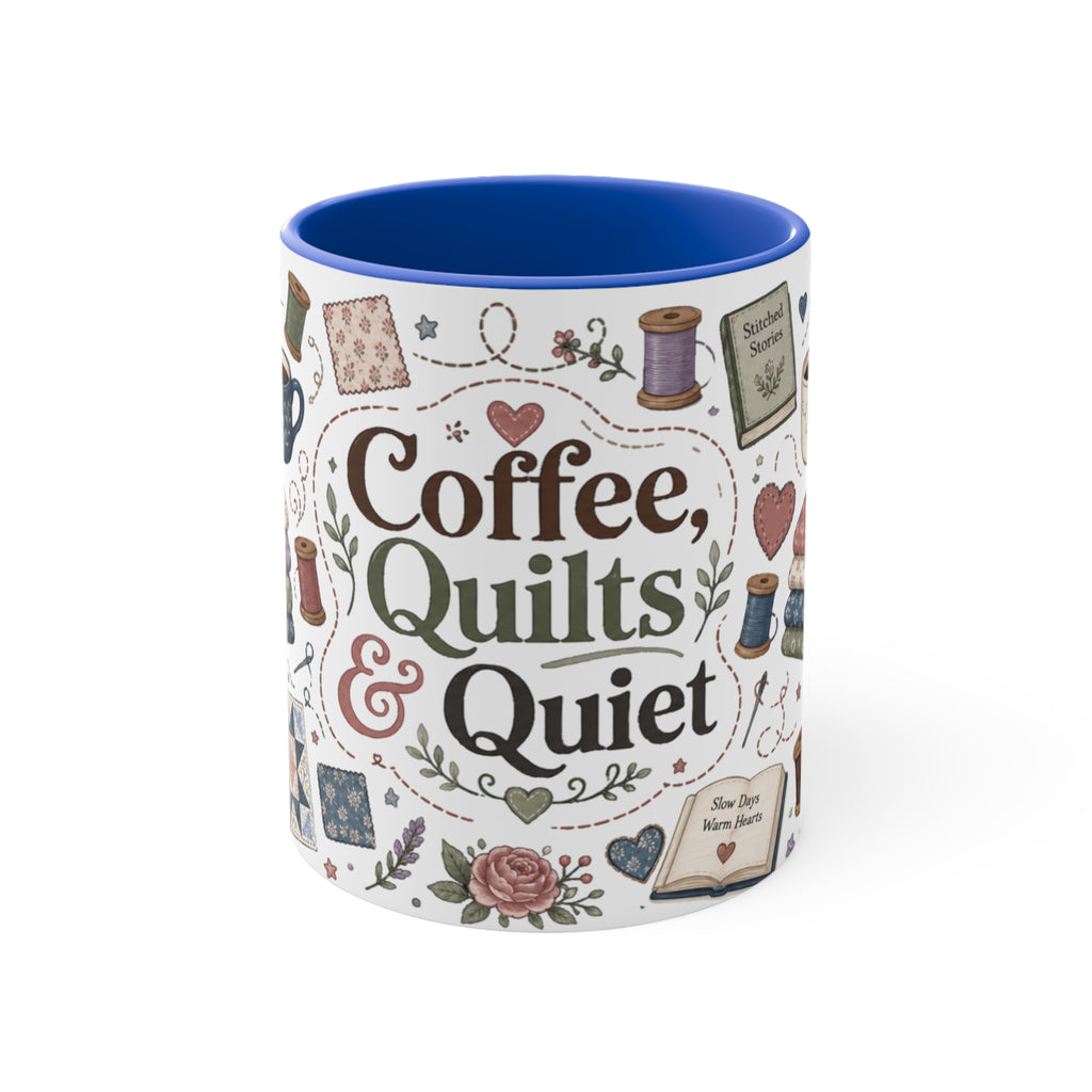 A white ceramic mug with a blue handle and blue interior, with the words 'Coffee, Quilts & Quiet' in the centre. It is decorated with quilting-themed illustrations including fabric stacks, sewing spools, a coffee cup, and quilt patterns on a white background. The handle is not visible.
