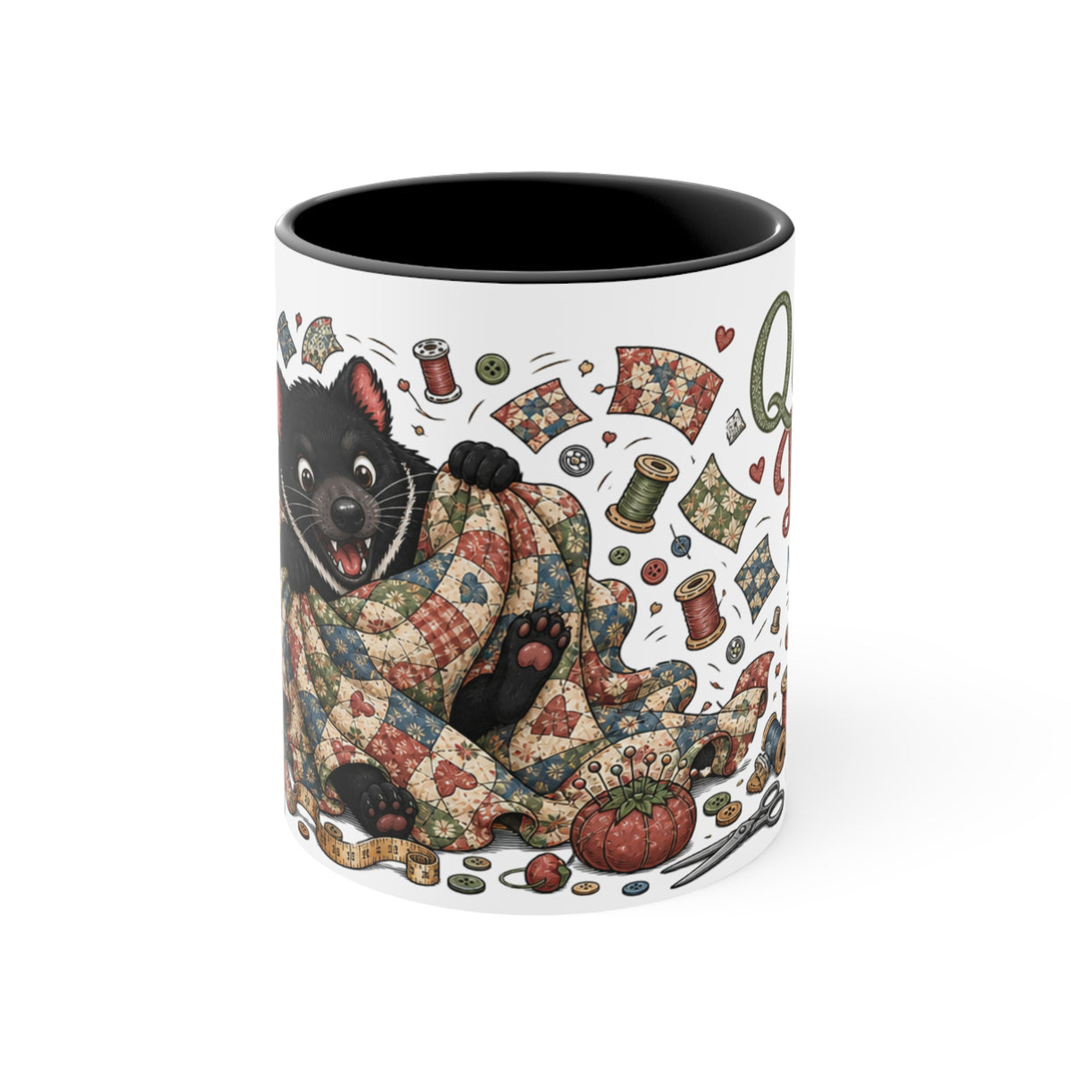A white ceramic mug with a black interior, featuring a whimsical illustration of a Tasmanian Devil wrapped in a patchwork quilt surrounded by sewing spools, fabric scraps, and hearts.