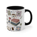 A white ceramic mug with a black handle shown on the right and black interior, decorated with quilting-themed illustrations including fabric stacks, sewing spools, a coffee cup, and quilt patterns on a white background. 