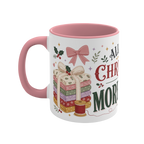 The left side of a white ceramic mug with a pink handle and interior, decorated with a bundle of fabric, a pink ribbon, thread spool and holly. The text 'All I Want for Christmas is More Fabric' is partially visible.