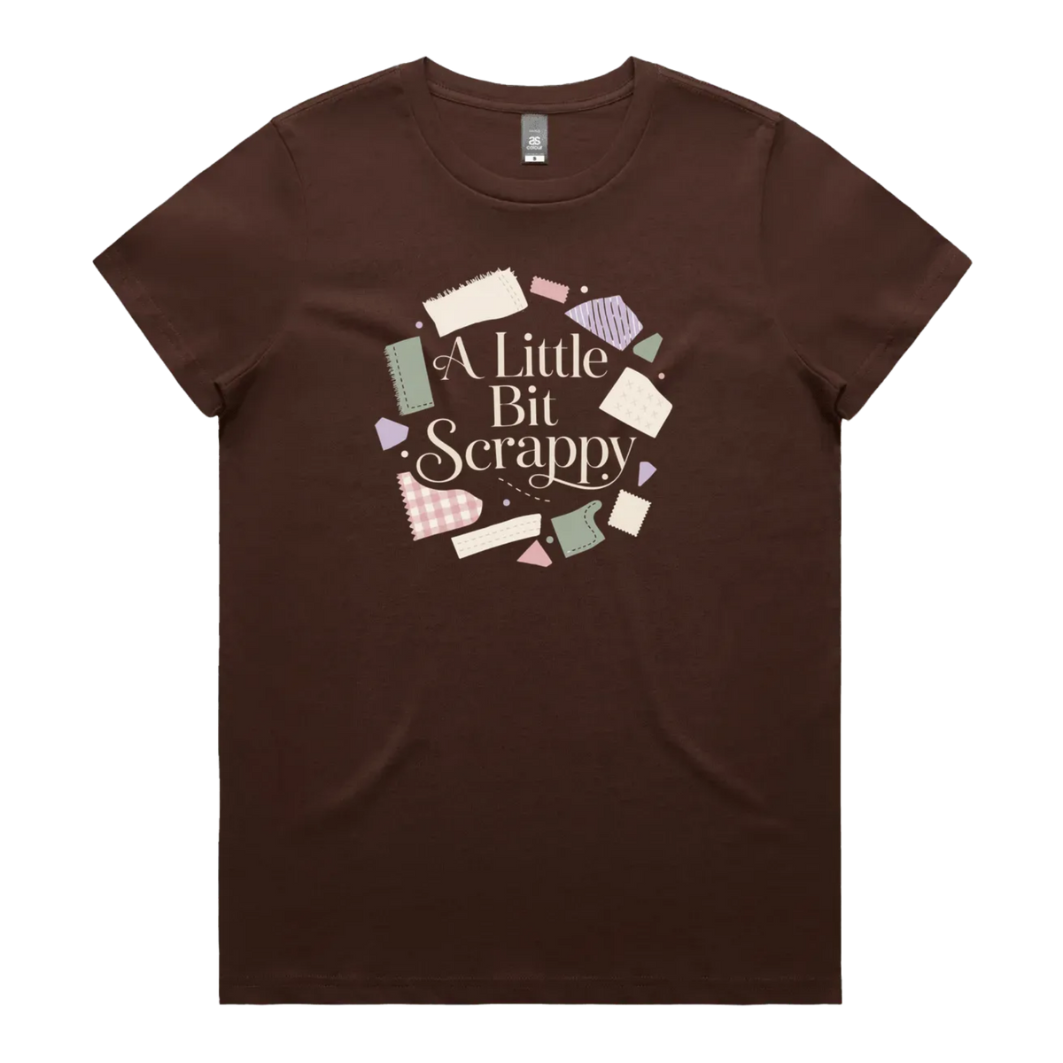 A dark brown short-sleeve crewneck t-shirt featuring a circular graphic on the chest with the text 'A Little Bit Scrappy' surrounded by small colorful fabric pieces.