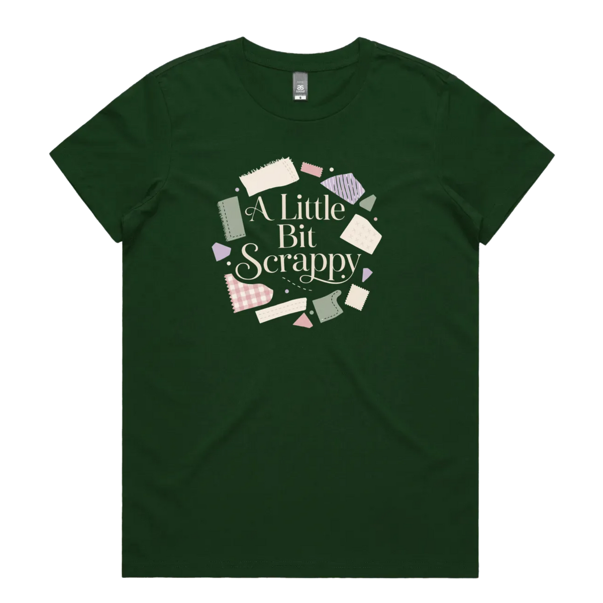A dark green short-sleeve crewneck t-shirt featuring a circular graphic on the chest with the text 'A Little Bit Scrappy' surrounded by small colorful fabric pieces.