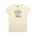 A pale butter yellow short-sleeve graphic t-shirt featuring the words 'A Very Productive Weekend, probably' above a stack of patchwork blocks and a thread spool.