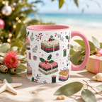 A white ceramic mug with pink handle and interior sitting on a light wooden board with gum leaves, a star fish and wrapped gift. There is an allover image on the mug of ribbon wrapped fabric bundles, thread spools, bobbins and holly.