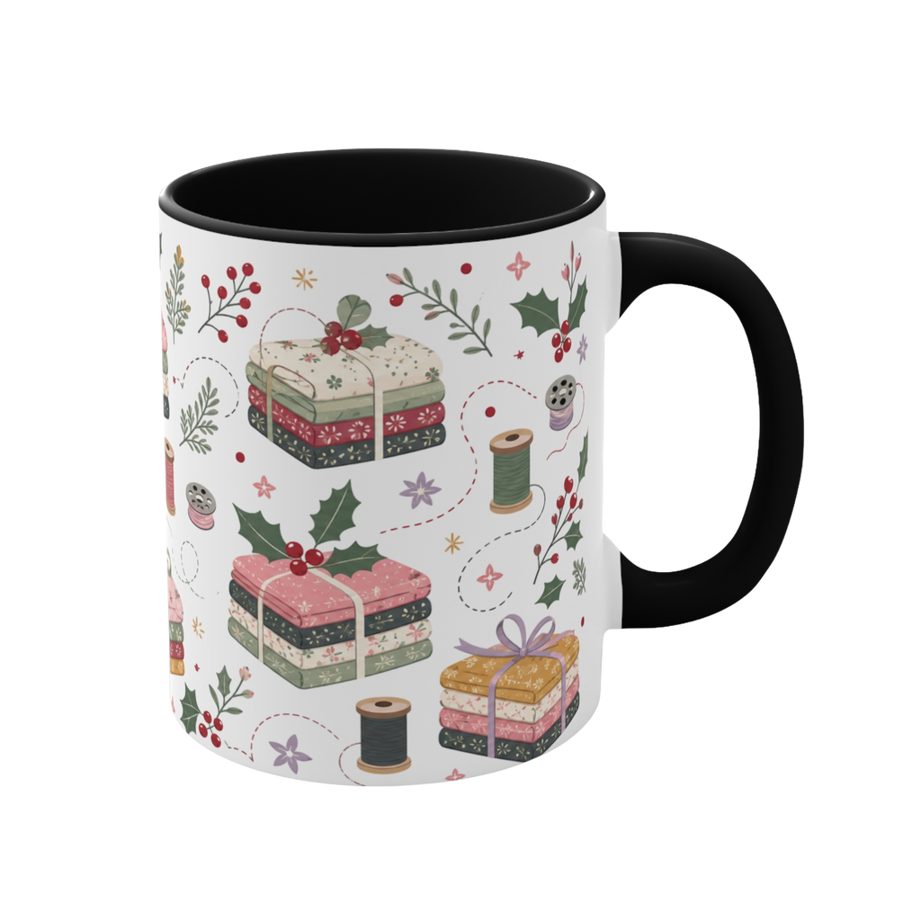 The right side of a white ceramic mug with a black handle and interior, decorated with a repeating pattern of stacked fabrics, holly leaves, berries, and thread spools in soft pink, green, beige, and brown tones.