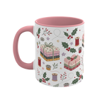 The left side of a white ceramic mug with a pink handle and interior, decorated with a repeating pattern of stacked fabrics, holly leaves, berries, and thread spools in soft pink, green, beige, and brown tones.