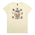 A pale butter yellow short-sleeve crewneck t-shirt featuring a colorful graphic print on the front with quilting-themed illustrations and the text 'I Quilt So I Don't Fray in Real Life'.