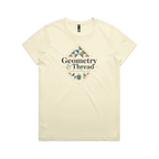 A pale butter yellow short-sleeve crewneck graphic t-shirt featuring the words 'Geometry & Thread, Modern Quilting Club' surrounded by patchwork triangles and a spool of thread.
