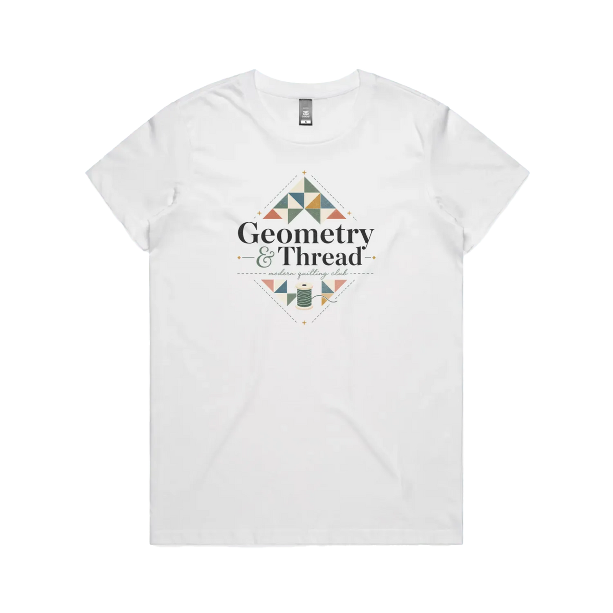 A white short-sleeve crewneck graphic t-shirt featuring the words 'Geometry & Thread, Modern Quilting Club' surrounded by patchwork triangles and a spool of thread.