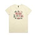 A light butter yellow short-sleeve crewneck t-shirt featuring a colorful graphic print on the front that reads 'Merry Stitchmas' in decorative lettering with Christmas and quilting-themed illustrations.