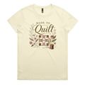 A very pale yellow short-sleeve crewneck t-shirt featuring a vintage-style quilt graphic with the text 'Made To Quilt' in brown script and floral illustrations.