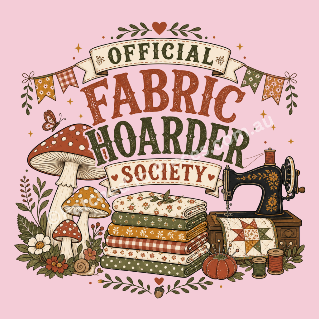 A detailed image of 'Official Fabric Hoarder' showing the wording in muted red and black. The words sit above a stack of folded fabrics, a sewing machine and a group of mushrooms. Small stars, flowers, thread spools and pincushion are also included in the design.