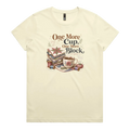 A pale butter yellow short-sleeve crewneck t-shirt featuring a vintage-style graphic of stacked quilt blocks, a coffee cup, and thread spools with the text 'One More Cup, One More Block' in brown and black lettering.
