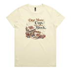 A pale butter yellow short-sleeve crewneck t-shirt featuring a vintage-style graphic of stacked quilt blocks, a coffee cup, and thread spools with the text 'One More Cup, One More Block' in brown and black lettering.