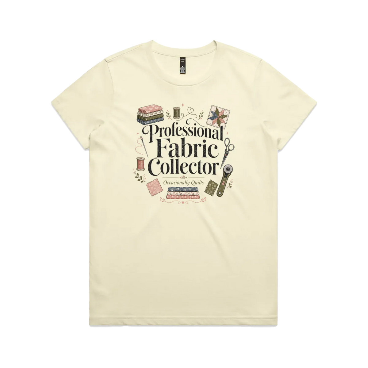 A pale butter yellow short-sleeve crewneck t-shirt with the words 'Professional Fabric Collector' surrounded by fabric bundles, swatches, thread and a patchwork star.