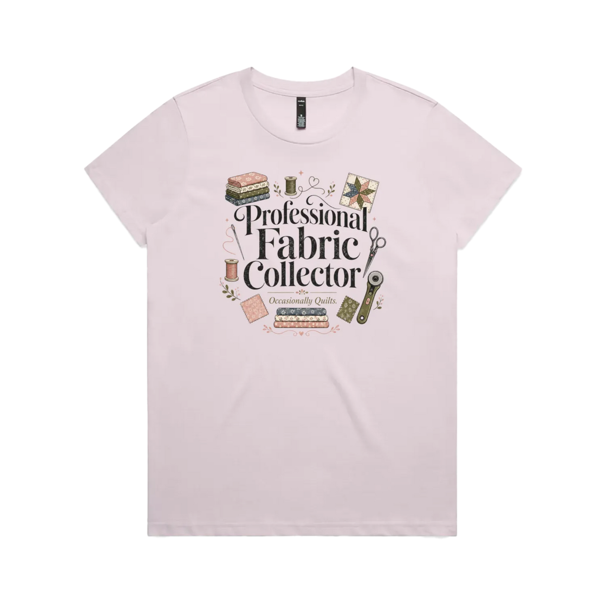 A pale mauve short-sleeve crewneck t-shirt with the words 'Professional Fabric Collector' surrounded by fabric bundles, swatches, thread and a patchwork star.