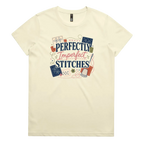 A pale butter yellow short-sleeve crewneck t-shirt featuring a colorful graphic print on the front with the text 'Perfectly Imperfect Stitches' surrounded by sashiko-themed illustrations.