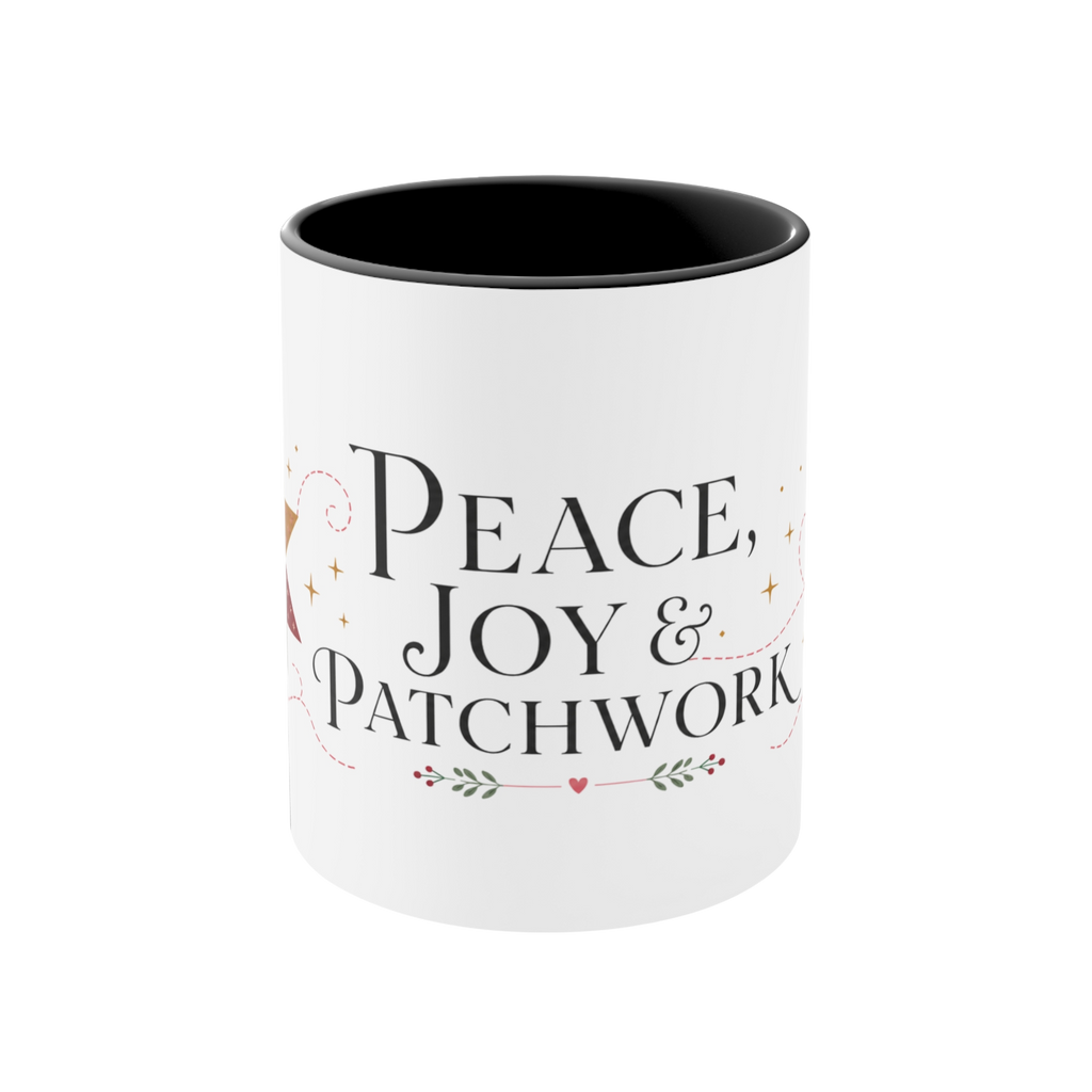 The front of a white ceramic mug with a black interior, featuring a festive Christmas-themed graphic that reads ‘Peace, Joy & Patchwork' in black lettering with small decorative accents.