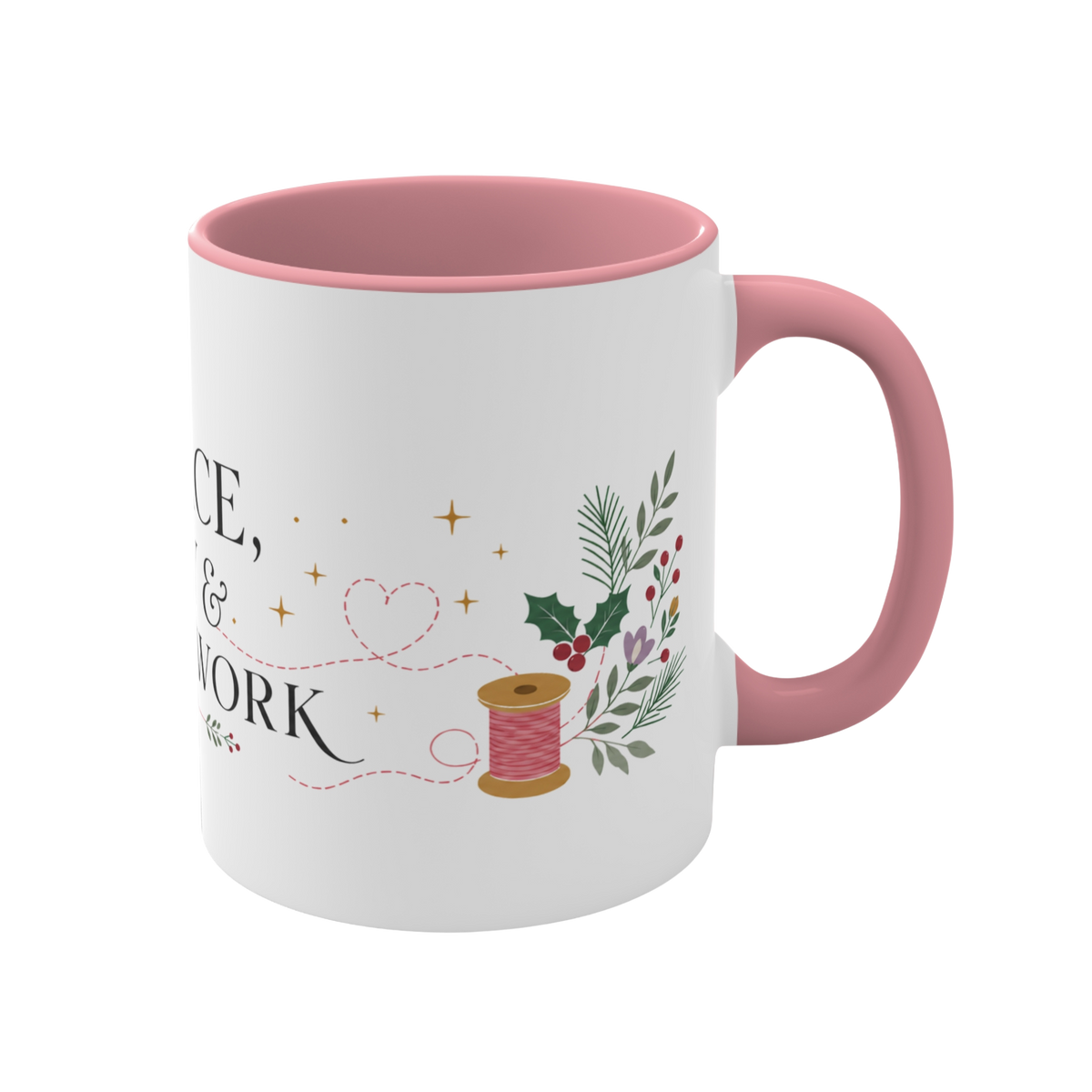 The right side of a white ceramic mug with a pink handle and interior, decorated with a thread spool, stitch lines, holly, berries and flowers. The text ‘Peace, Joy & Patchwork' is partially visible.