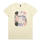 A very pale yellow short-sleeve crewneck t-shirt featuring a central square graphic with a patchwork design of pastel-colored home-themed illustrations and the text 'Pieces of Home'.