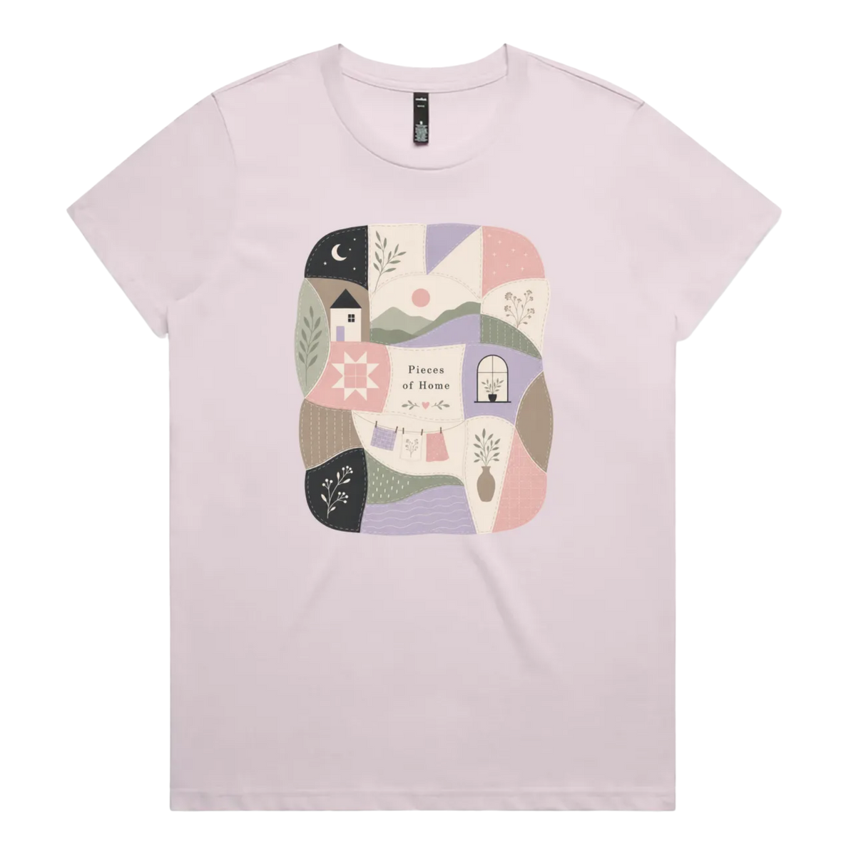 A light mauve short-sleeve crewneck t-shirt featuring a central square graphic with a patchwork design of pastel-colored home-themed illustrations and the text 'Pieces of Home'.