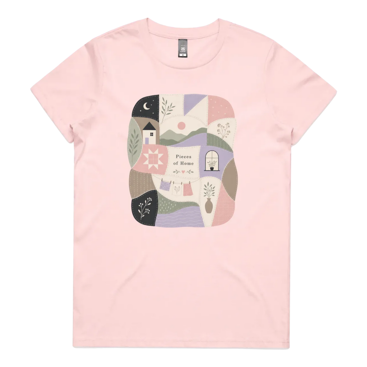 A light pink short-sleeve crewneck t-shirt featuring a central square graphic with a patchwork design of pastel-colored home-themed illustrations and the text 'Pieces of Home'.