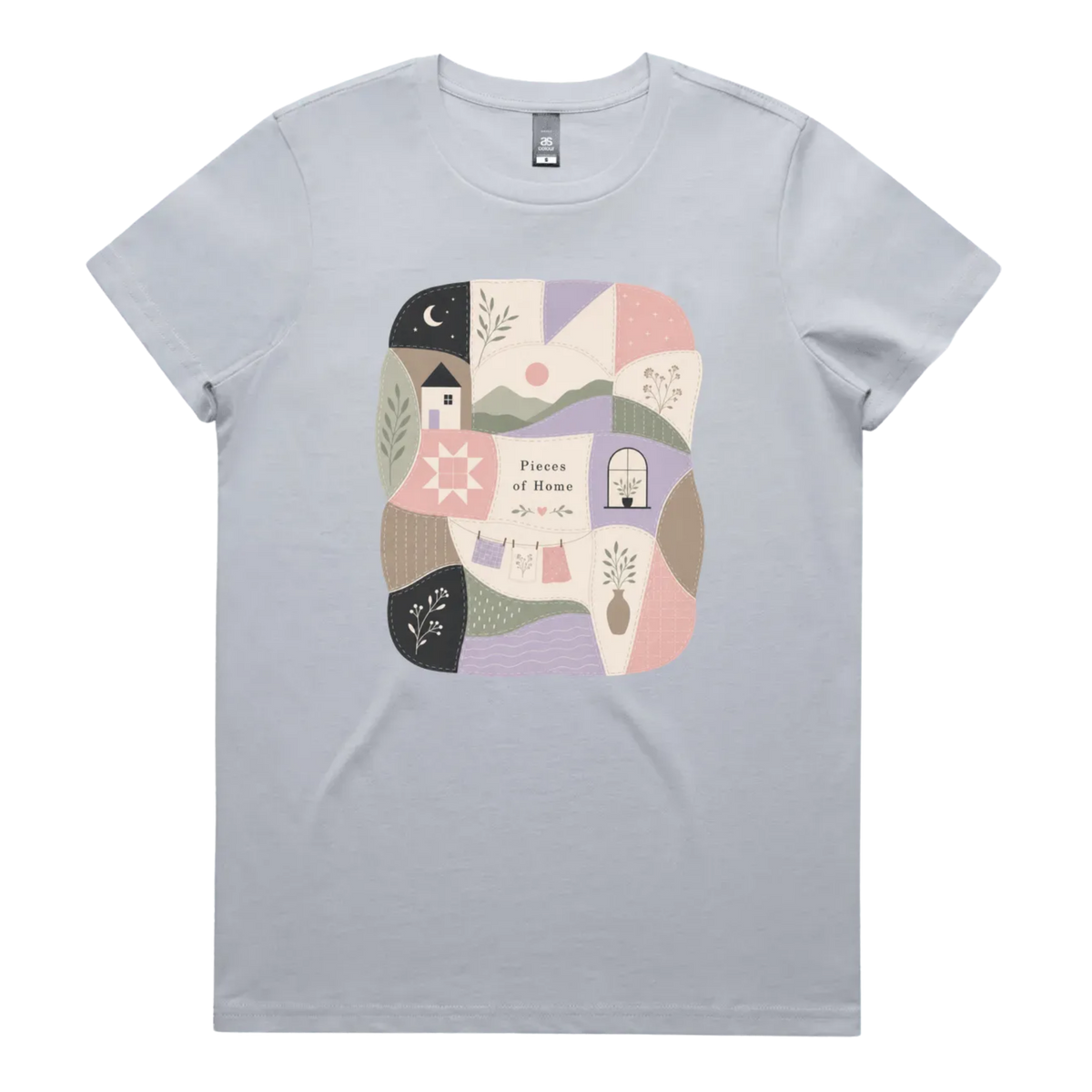 A light powder blue short-sleeve crewneck t-shirt featuring a central square graphic with a patchwork design of pastel-colored home-themed illustrations and the text 'Pieces of Home'.