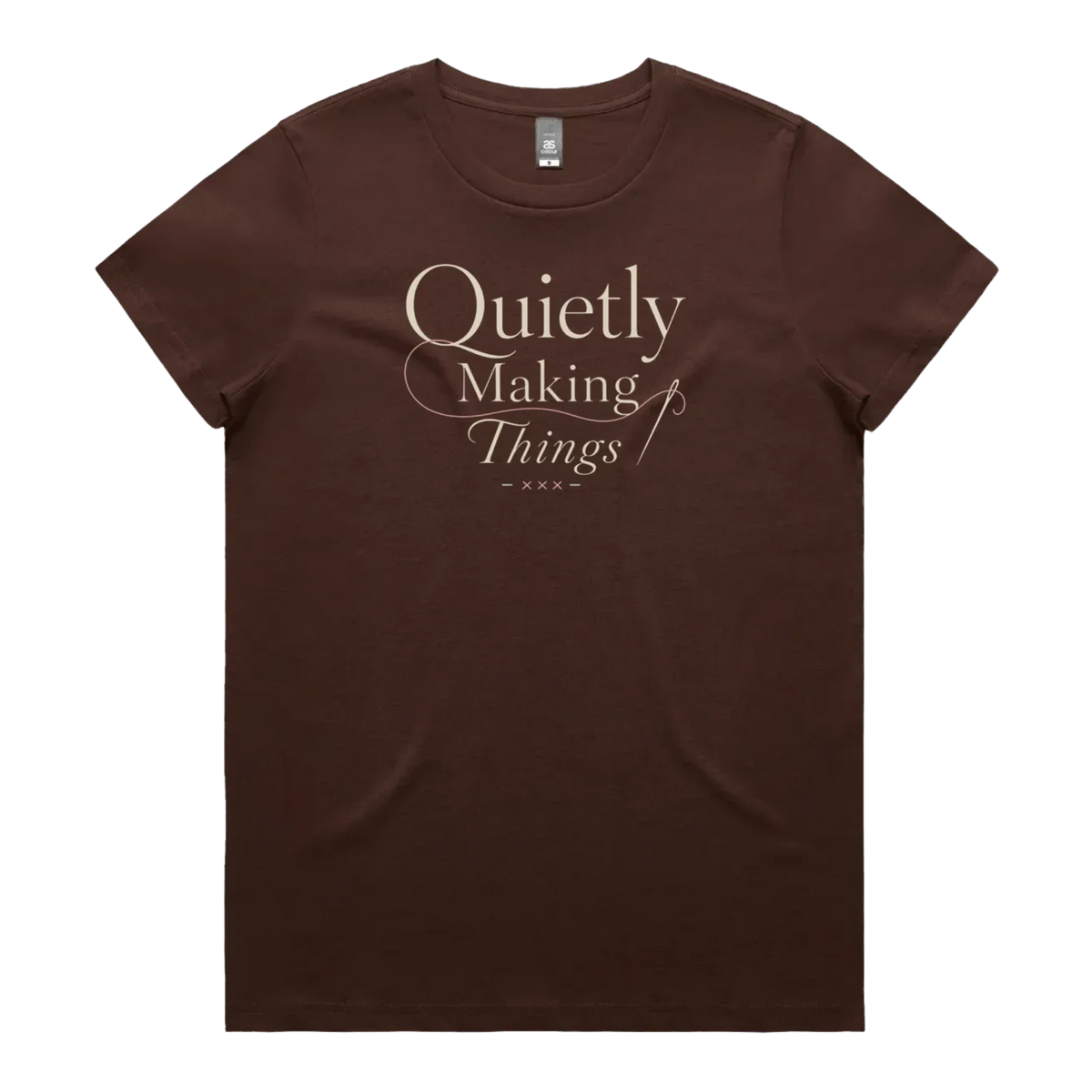 A dark brown short-sleeve crewneck t-shirt featuring a cream-colored graphic print on the front that reads 'Quietly Making Things' in an elegant serif and script font with needle and thread accents.