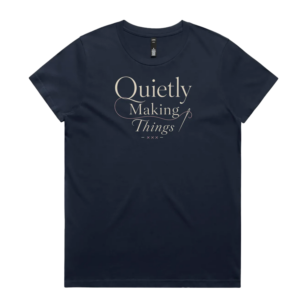 A midnight blue short-sleeve crewneck t-shirt featuring a cream-colored graphic print on the front that reads 'Quietly Making Things' in an elegant serif and script font with needle and thread accents.