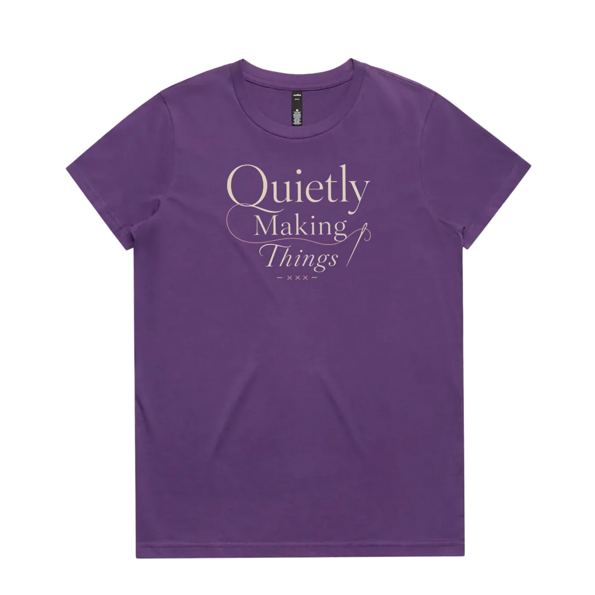 A purple short-sleeve crewneck t-shirt featuring a cream-colored graphic print on the front that reads 'Quietly Making Things' in an elegant serif and script font with needle and thread accents.