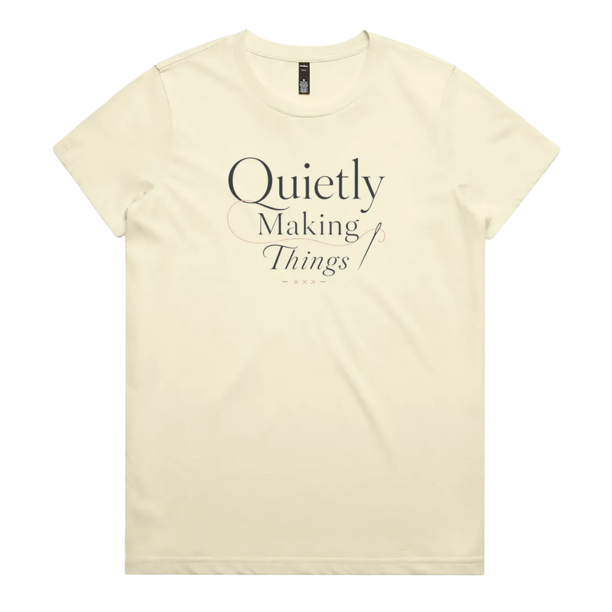 A pale butter yellow short-sleeve crewneck t-shirt with a dark gray text graphic on the front reading 'Quietly Making Things' with needle and thread accents.
