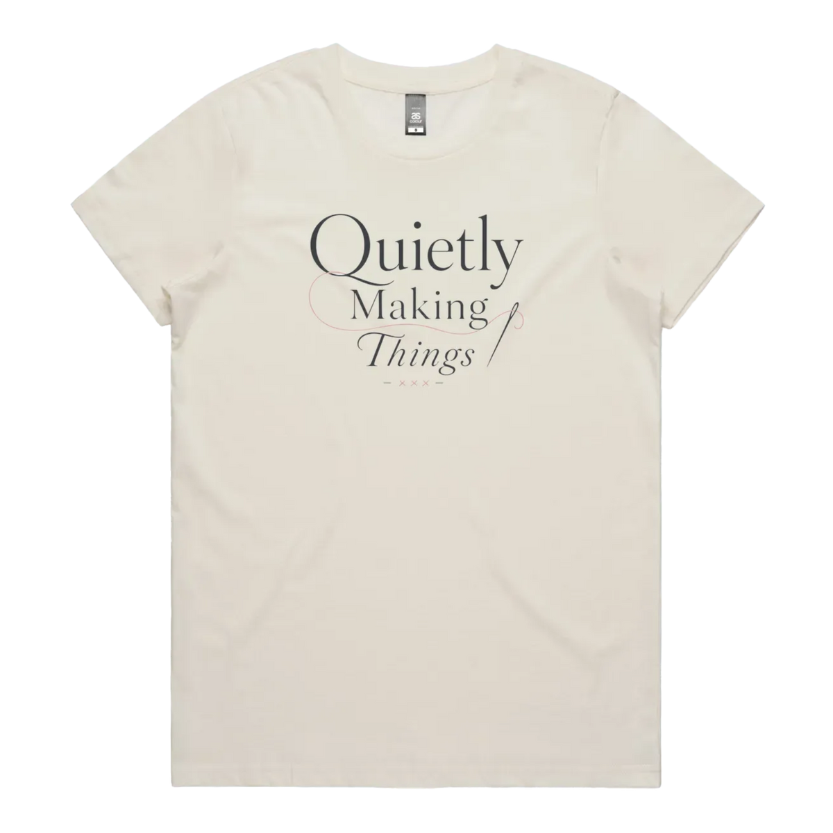 A pale cream short-sleeve crewneck t-shirt with a dark gray text graphic on the front reading 'Quietly Making Things' with needle and thread accents.