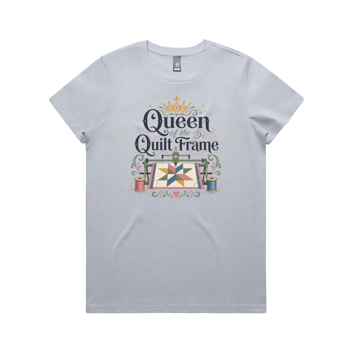 A powder blue short-sleeve t-shirt with a graphic print on the front that reads 'Queen of the Quilt Frame' in black script, decorated with a gold crown, a quilt design, and spools of thread.