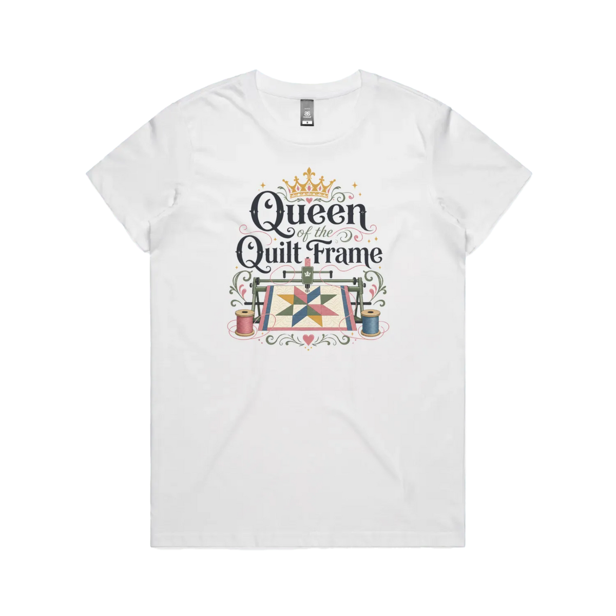 A white short-sleeve t-shirt with a graphic print on the front that reads 'Queen of the Quilt Frame' in black script, decorated with a gold crown, a quilt design, and spools of thread.