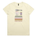 A light butter yellow short-sleeve crewneck t-shirt featuring a graphic of sewing and crafting essentials (a rotary cutter, mug, fabric stack, spool of thread) with the text 'RETREAT ESSENTIALS' printed below.
