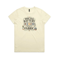 A pale butter yellow short-sleeve t-shirt with the graphic 'Social Battery Powered By Fabric'. Illustrations of patchwork blocks inside a battery, quilting tools and small leaves add decoration.