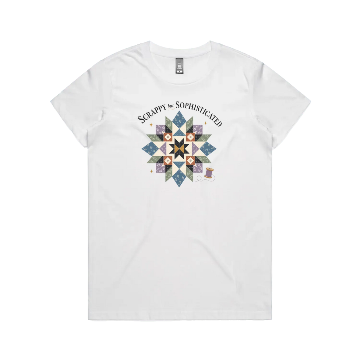 A white short-sleeve crewneck tshirt with the words 'Scrappy but Sophisticated' above a large star quilt block with a purple thread spool on the bottom right.