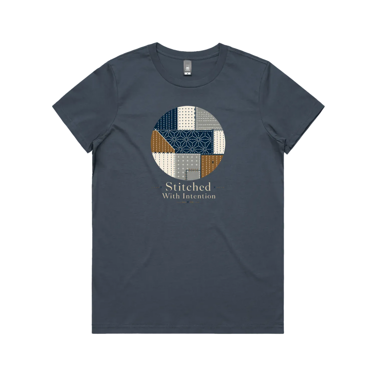 A petrol blue short-sleeve crewneck t-shirt featuring a circular graphic on the chest with geometric sashiko stitched patterns in navy, beige, and brown, with the text 'Stitched With Intention' printed below.