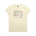 A pale butter yellow short-sleeve t-shirt with the words 'Sewing Weekend plans firmly made' across the front in multi-coloured letters.