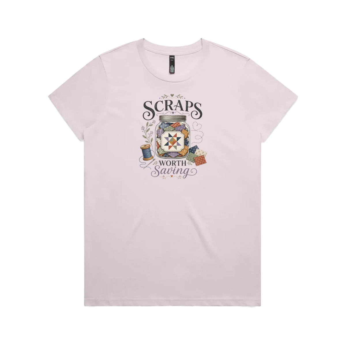 A pale mauve short-sleeve t-shirt with the graphic 'Scraps Worth Saving' surrounding a jar filled with small fabric swatches.
