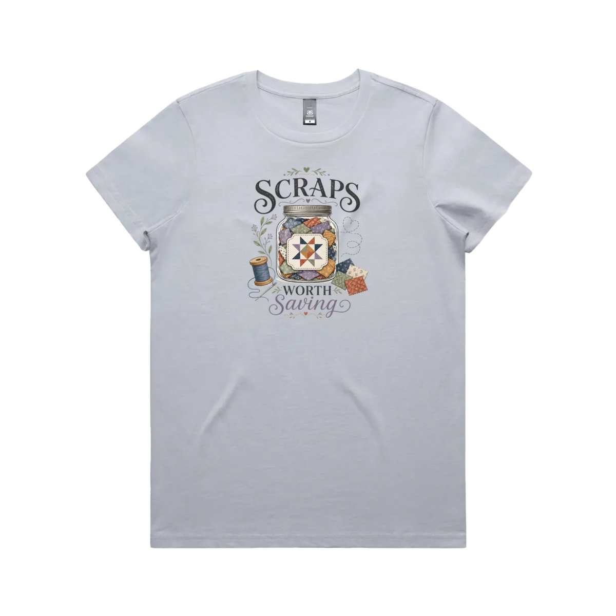 A powder blue short-sleeve t-shirt with the graphic 'Scraps Worth Saving' surrounding a jar filled with small fabric swatches.