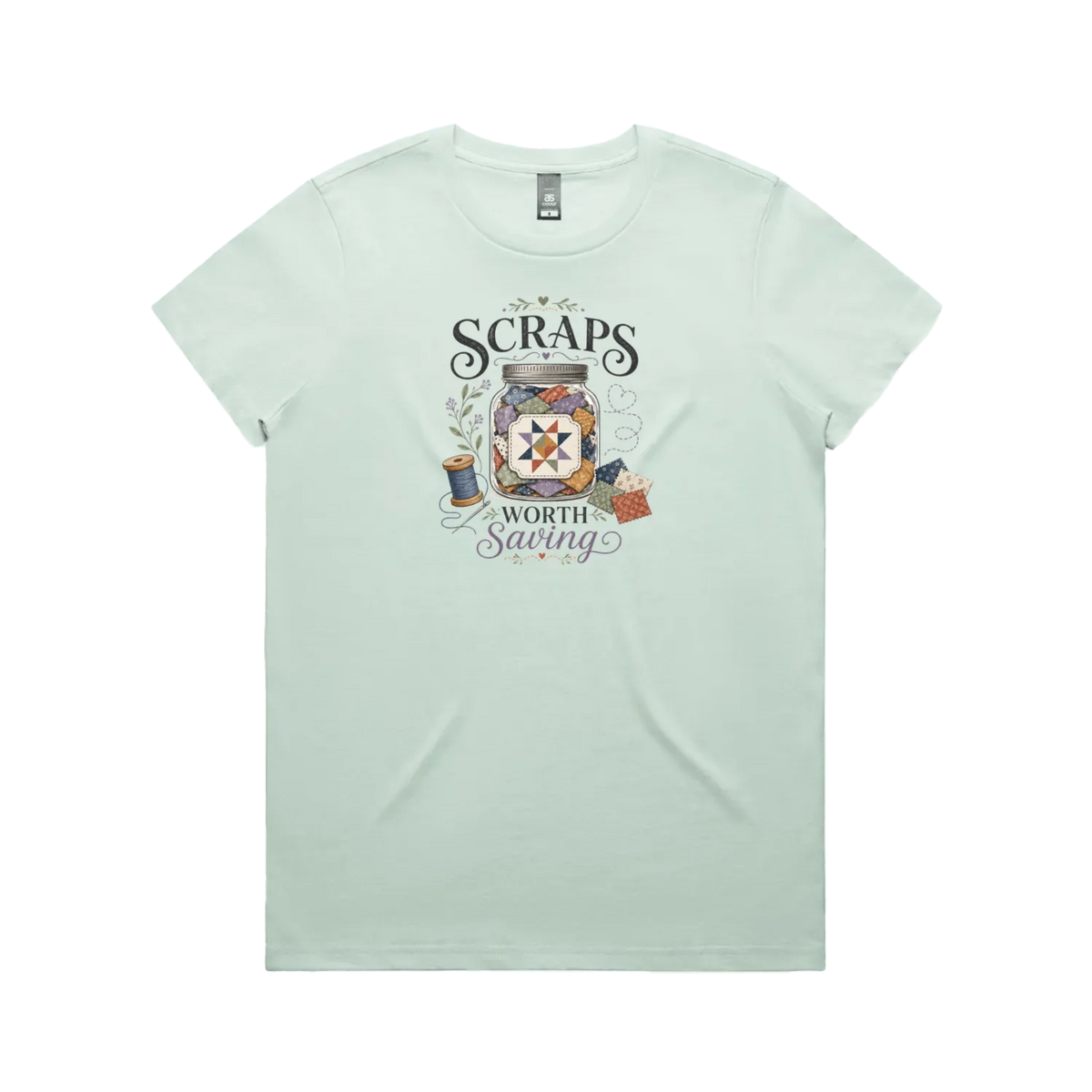 A pale mint green short-sleeve t-shirt with the graphic 'Scraps Worth Saving' surrounding a jar filled with small fabric swatches.