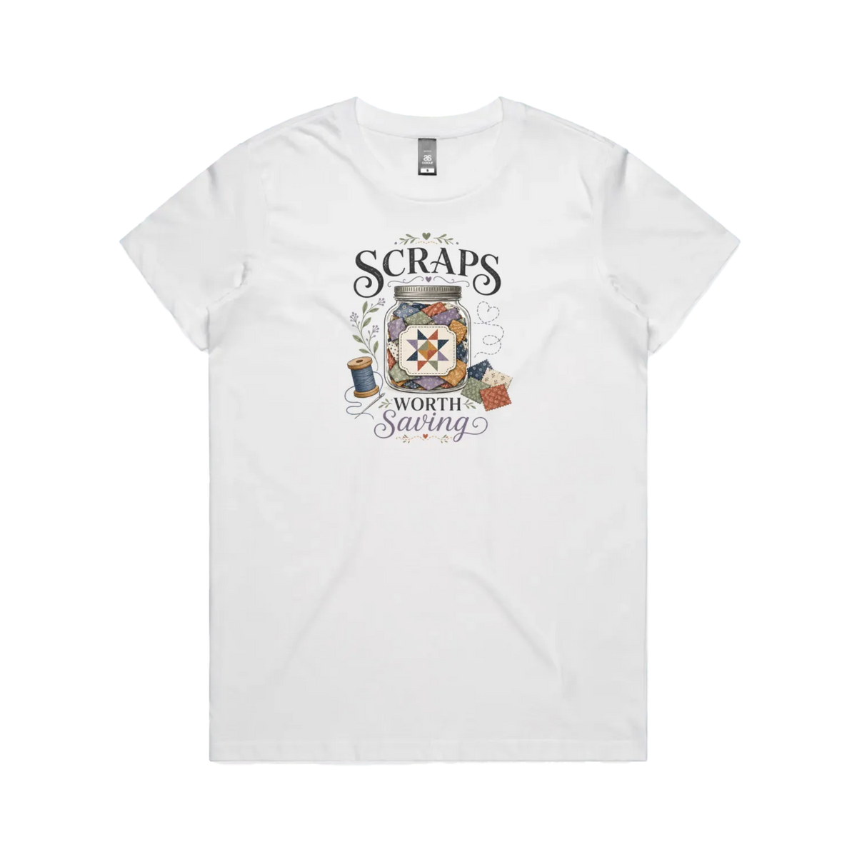 A white short-sleeve t-shirt with the graphic 'Scraps Worth Saving' surrounding a jar filled with small fabric swatches.