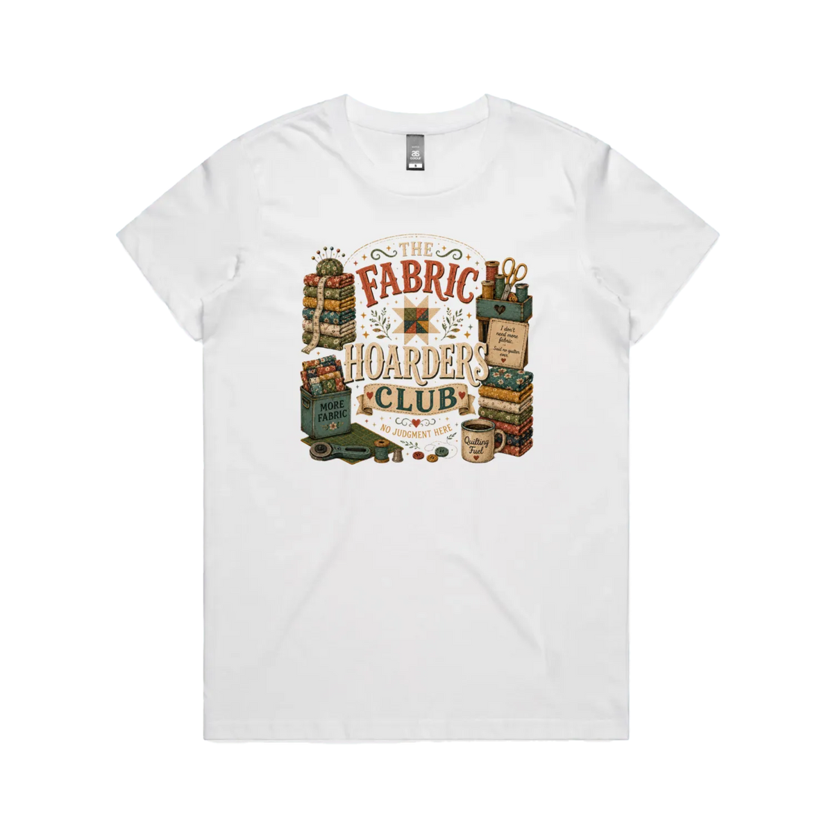 A white short-sleeve crewneck t-shirt with a vintage style graphic featuring the words 'The Fabric Hoarders Club' surrounded by fabric stacks, a coffee mug and quilting tools.